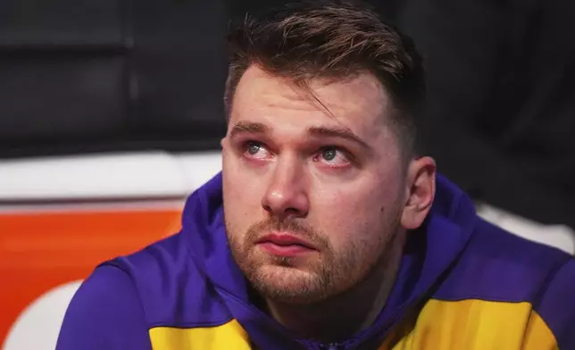 Los Angeles Lakers' Luka Doncic becomes emotional as he watches a video on the large video board that was a tribute to the former Dallas Mavericks player before an NBA basketball game in Dallas, Wednesday, April 9, 2025. (AP Photo/LM Otero)