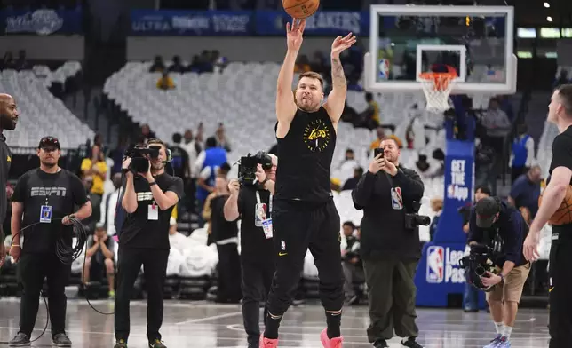 Los Angeles Lakers' Luka Doncic warms up before an NBA basketball game against the Dallas Mavericks in Dallas, Wednesday, April 9, 2025. (AP Photo/LM Otero)