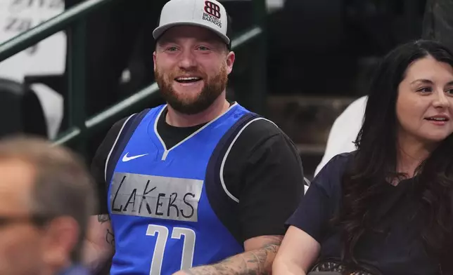 A fan wears a Dallas Mavericks jersey with tape and writing on it that reads "Lakers" and former player Luka Doncic's number on it during warmups before an NBA basketball game against the Los Angeles Lakers in Dallas, Wednesday, April 9, 2025. (AP Photo/LM Otero)