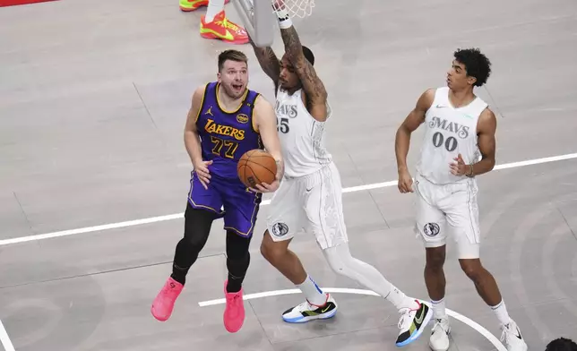 Los Angeles Lakers' Luka Doncic (77) shoots as Dallas Mavericks' P.J. Washington (25) and Max Christie (00) defend in the second half of an NBA basketball game in Dallas, Wednesday, April 9, 2025. (AP Photo/Julio Cortez)