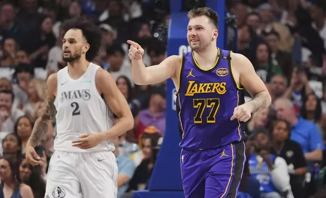 Los Angeles Lakers' Luka Doncic (77) celebrates sinking a basket as Dallas Mavericks' Dereck Lively II (2) follows behind in the first half of an NBA basketball game in Dallas, Wednesday, April 9, 2025. (AP Photo/LM Otero)