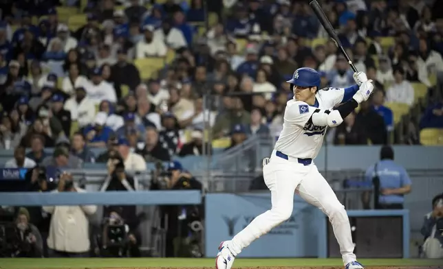 Los Angeles Dodgers' Shohei Ohtani bats during the third inning of a baseball game against the Colorado Rockies in Los Angeles, Tuesday, April 15, 2025. (AP Photo/Kyusung Gong)