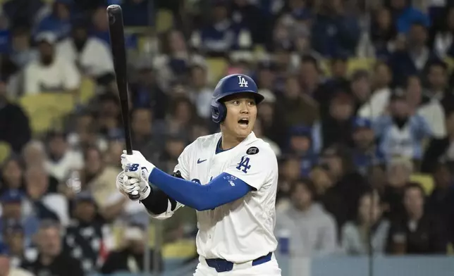 Los Angeles Dodgers' Shohei Ohtani yells after hitting a foul ball towards the stands during the third inning of a baseball game against the Colorado Rockies in Los Angeles, Tuesday, April 15, 2025. (AP Photo/Kyusung Gong)