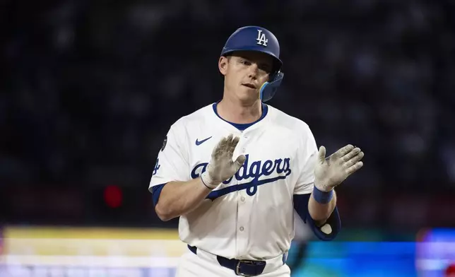 Los Angeles Dodgers' Will Smith celebrates after hitting a three-run home run during the third inning of a baseball game against the Colorado Rockies in Los Angeles, Tuesday, April 15, 2025. (AP Photo/Kyusung Gong)