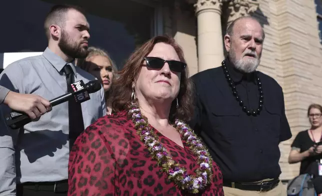 FILE - Kay Woodcock, center, and Larry Woodcock, right, address the media outside court at a hearing for Lori Vallow Daybell on Friday, March 6, 2020, in Rexburg, Idaho. (John Roark/The Idaho Post-Register via AP, Pool)