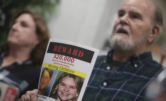FILE - Larry Woodcock speaks to media members at the Rexburg Standard Journal Newspaper in Rexburg, Idaho on Jan. 7, 2020, while holding a reward flyer for Joshua Vallow and Tylee Ryan. (John Roark/The Idaho Post-Register via AP, File)