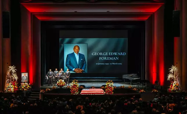 George Foreman IV stands with his brothers as he says the eulogy for his father during a memorial service for Olympic and world champion boxer and minister George Foreman at Wortham Theater Center in Houston, Monday, April 14, 2025. (Brett Coomer/Houston Chronicle via AP)