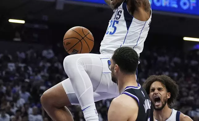 Dallas Mavericks forward P.J. Washington (25) dunks next to Sacramento Kings guard Zach LaVine (8) during the first half of an NBA play-in tournament basketball game Wednesday, April 16, 2025, in Sacramento, Calif. (AP Photo/Godofredo A. Vásquez)