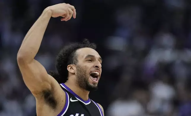 Sacramento Kings guard Devin Carter reacts after making a 3-point basket during the first half of an NBA play-in tournament basketball game against the Dallas Mavericks, Wednesday, April 16, 2025, in Sacramento, Calif. (AP Photo/Godofredo A. Vásquez)