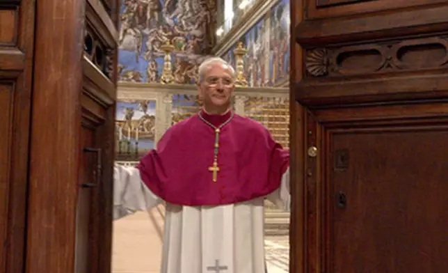 FILE - Master of Liturgical Celebrations Archbishop Piero Marini closes the door of the Sistine Chapel at the Vatican, after proclaiming the "extra omnes", which is the Latin order for all those not taking part in the conclave to leave the chapel, at the beginning of the conclave, on April 18, 2005. (Osservatore Romano via AP, File)