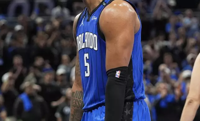 Orlando Magic forward Paolo Banchero (5) celebrates after teammate forward Franz Wagner made a shot against the Atlanta Hawks during the second half of an NBA play-in tournament basketball game, Tuesday, April 15, 2025, in Orlando, Fla. (AP Photo/John Raoux)