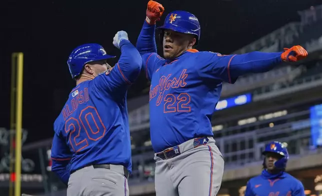 New York Mets' Juan Soto (22) celebrates with Pete Alonso (20) after hitting a two-run home run during the seventh inning of a baseball game against the Minnesota Twins, Monday, April 14, 2025, in Minneapolis. (AP Photo/Abbie Parr)