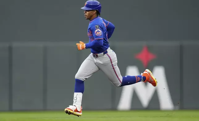 New York Mets' Francisco Lindor (12) runs to second base after hitting a double during the first inning of a baseball game against the Minnesota Twins, Monday, April 14, 2025, in Minneapolis. (AP Photo/Abbie Parr)