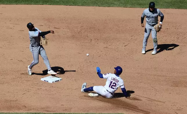 Miami Marlins shortstop Xavier Edwards, left, turns a double play on a ball hit by New York Mets' Juan Soto after forcing out New York Mets' Francisco Lindor, center, at second during the sixth inning of a baseball game, Wednesday, April 9, 2025, in New York. (AP Photo/Pamela Smith)