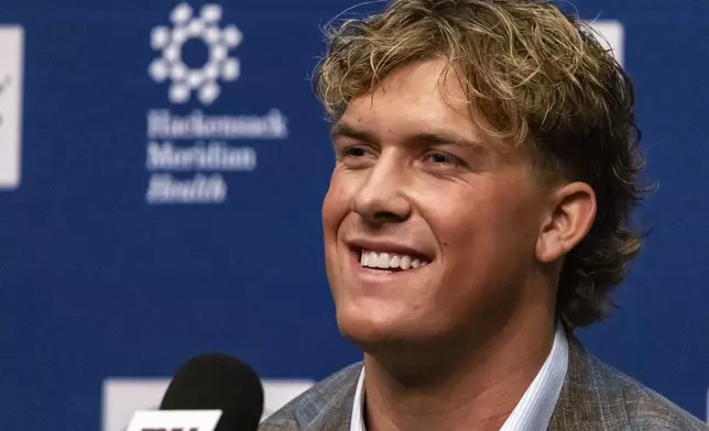 New York Giants first-round draft pick Jaxson Dart speaks to reporters at a news conference at the NFL football team's training center in East Rutherford, N.J., Friday, April 25, 2025. (AP Photo/Stefan Jeremiah)