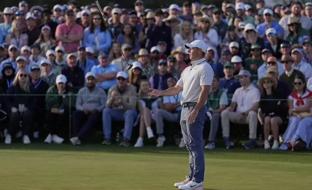 Rory McIlroy, of Northern Ireland, tosses his putter on the 18th hole during the third round at the Masters golf tournament, Saturday, April 12, 2025, in Augusta, Ga. (AP Photo/Ashley Landis)