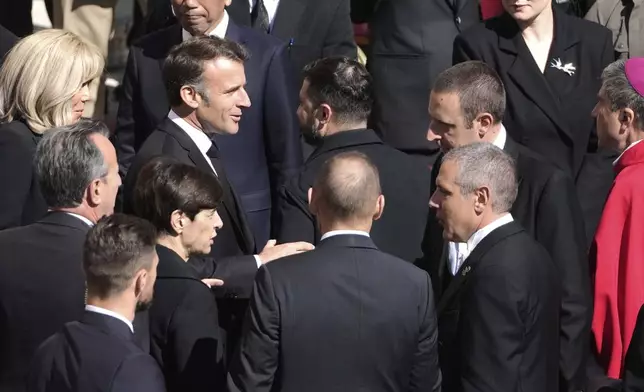 French President Emmanuel Macron, center left, speaks with Ukraine's President Volodymr Zelenskyy, center right, as they arrive for the funeral of Pope Francis in St. Peter's Square at the Vatican, Saturday, April 26, 2025. (AP Photo/Markus Schreiber)