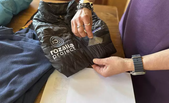 Rachael Z. Miller, founder of the Vermont-based Rozalia Project for a Clean Ocean, conducts a tape test on various clothing items to compare how much each material sheds microfibers on Thursday, April 17, 2025, in Granville, Vt. (AP Photo/Amanda Swinhart)