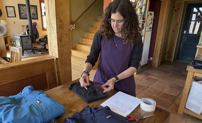 Rachael Z. Miller, founder of the Vermont-based Rozalia Project for a Clean Ocean, conducts a tape test on various clothing items to compare how much each material sheds microfibers on Thursday, April 17, 2025, in Granville, Vt. (AP Photo/Amanda Swinhart)