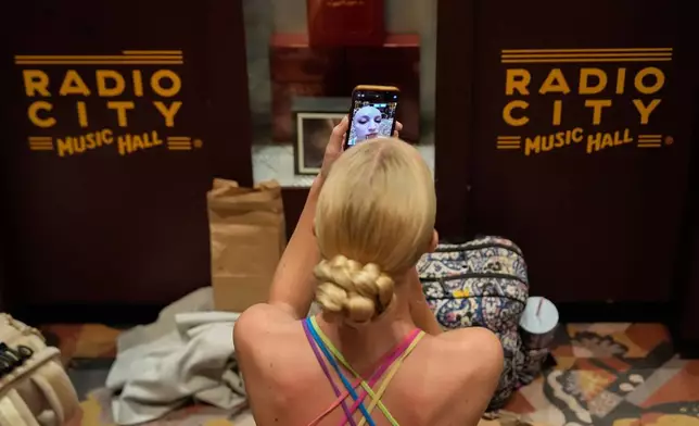 A dancer applies make up before an audition for the Radio City Rockettes at Radio City Music Hall, Tuesday, April 22, 2025, in New York. (AP Photo/Julia Demaree Nikhinson)