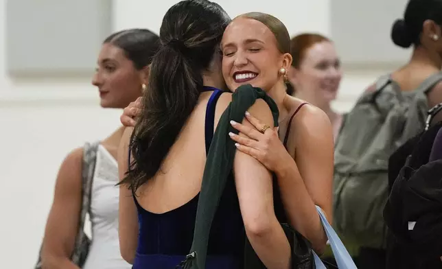 Dancers react after advancing to the next round of auditions for the Radio City Rockettes at Radio City Music Hall, Tuesday, April 22, 2025, in New York. (AP Photo/Julia Demaree Nikhinson)
