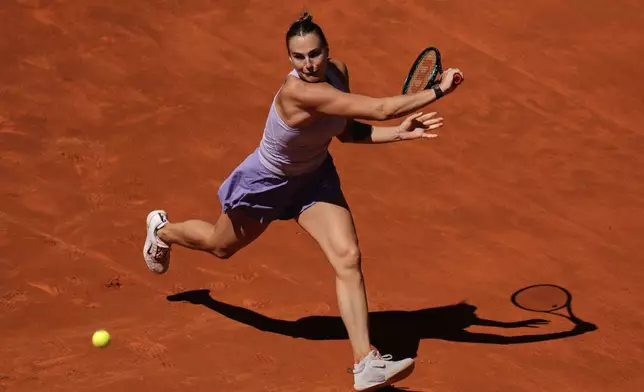 Aryna Sabalenka of Belarus returns the ball to Elise Mertens of Belgium during the Madrid Open tennis tournament in Madrid, Spain, Sunday, April 27, 2025. (AP Photo/Manu Fernandez)