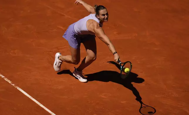 Aryna Sabalenka of Belarus returns the ball to Elise Mertens of Belgium during the Madrid Open tennis tournament in Madrid, Spain, Sunday, April 27, 2025. (AP Photo/Manu Fernandez)