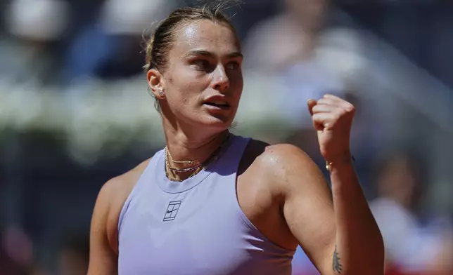 Aryna Sabalenka of Belarus celebrates after her victory over Elise Mertens of Belgium during the Madrid Open tennis tournament in Madrid, Spain, Sunday, April 27, 2025. (AP Photo/Manu Fernandez)