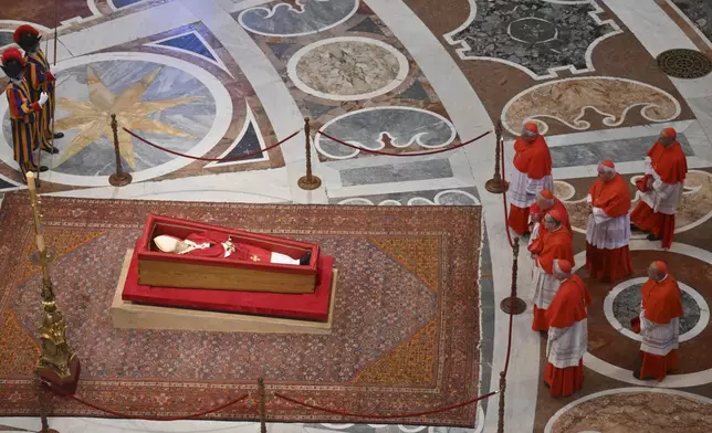 Cardinals pay their respects to late Pope Francis inside St. Peter's Basilica at the Vatican, Wednesday, April 23, 2025, where he will lie in state for three days. (Alessandro Di Meo/Pool Photo via AP)