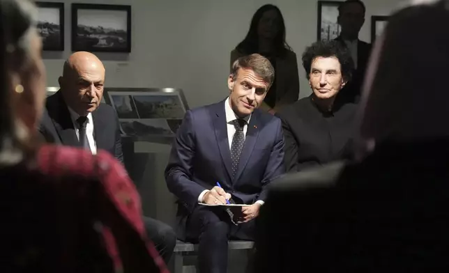 French President Emmanuel Macron, center, Hani al-Hayek, left, the Palestinian Authority's minister for heritage and tourism and IM director Jack Lang listen as they visit the exhibition "Treasures rescued from Gaza" Monday, April 14, 2025 at the Arab World Institute (IMA) in Paris. (AP Photo/Michel Euler, Pool)