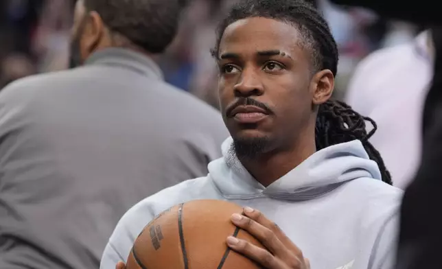 Memphis Grizzlies guard Ja Morant watches from the bench during the first half in Game 4 of an NBA basketball first-round playoff series against the Oklahoma City Thunder, Saturday, April 26, 2025, in Memphis, Tenn. (AP Photo/George Walker IV)