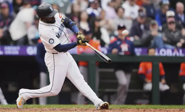 Seattle Mariners' Randy Arozarena hits a grand slam against the Houston Astros during the eighth inning of a baseball game Wednesday, April 9, 2025, in Seattle. (AP Photo/Lindsey Wasson)