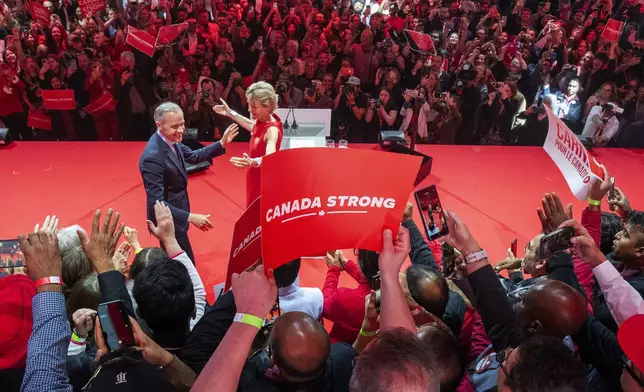 Canadian Prime Minister Mark Carney and his wife Diana Fox Carney react on stage at his campaign headquarters after the Liberal Party won the Canadian election in Ottawa on Tuesday, April 29, 2025. (Frank Gunn/The Canadian Press via AP)