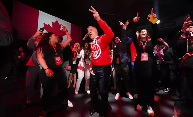 Canadian Prime Minister Mark Carney, center, dances to Canadian band Down With Webster as they play live from campaign headquarters after the Liberal Party won the Canadian election in Ottawa on Tuesday, April 29, 2025. (Sean Kilpatrick/The Canadian Press via AP)
