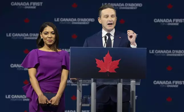 Conservative Leader Pierre Poilievre with his wife Anaida speaks Tuesday, April 29, 2025 in Ottawa. (Adrian Wyld/The Canadian Press via AP)