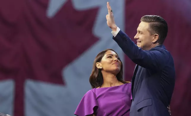 Conservative Leader Pierre Poilievre and his wife Anaida at his campaign headquarters on election night, in Ottawa, Tuesday, April 29, 2025. (Christinne Muschi/The Canadian Press via AP)