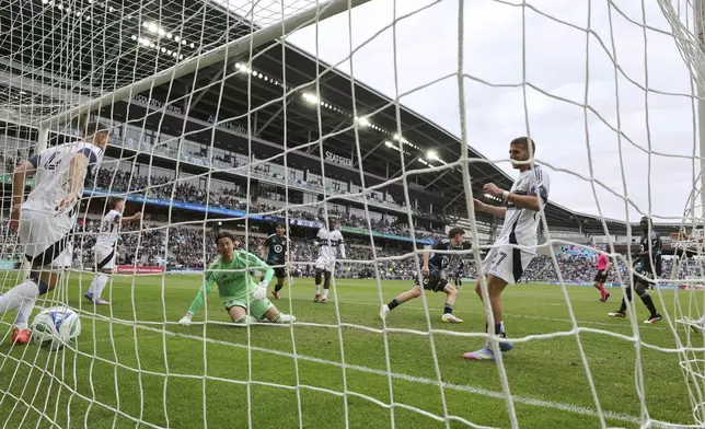 Minnesota United midfielder Will Trapp, center right, turns away after scoring against the Vancouver Whitecaps during the second half of an MLS soccer match Sunday, April 27, 2025, in St. Paul, Minn. (AP Photo/Adam Bettcher)