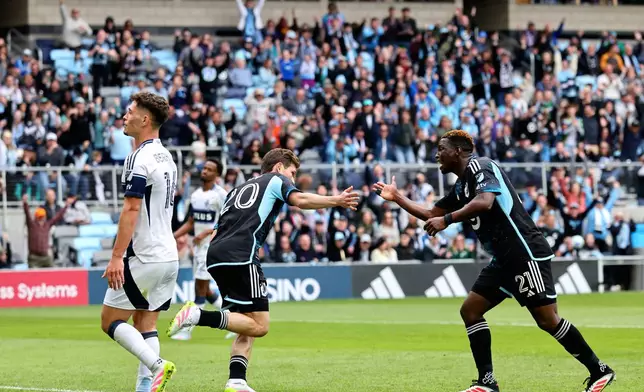 Minnesota United midfielder Wil Trapp (20) celebrates his goal with Minnesota United forward Bongokuhle Hlongwane (21) during the second half of an MLS soccer match against the Vancouver Whitecaps, Sunday, April 27, 2025, in St. Paul, Minn. (AP Photo/Adam Bettcher)