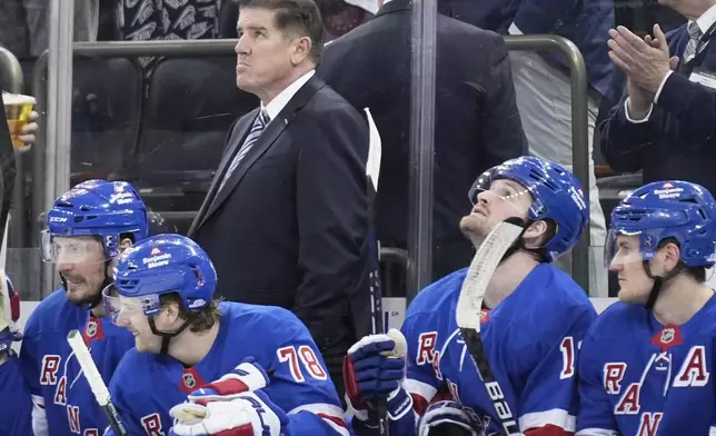 New York Rangers coach Peter Laviolette looks up during the third period of an NHL hockey game against the Tampa Bay Lightning in New York, Thursday, April 17, 2025. (AP Photo/Seth Wenig)