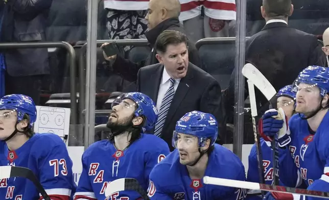 New York Rangers coach Peter Laviolette talks to this team during the second period of an NHL hockey game against the Tampa Bay Lightning in New York, Thursday, April 17, 2025. (AP Photo/Seth Wenig)
