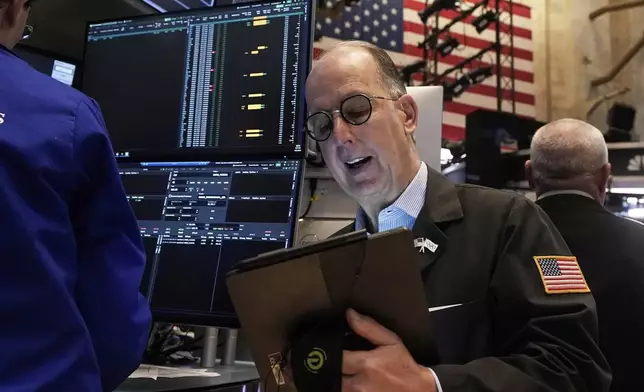 Trader Joe Dente works on the floor of the New York Stock Exchange, Tuesday, April 22, 2025. (AP Photo/Richard Drew)