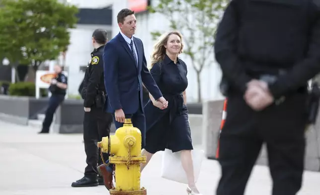 Former Grand Rapids City Police officer Christopher Schurr and wife Brandey arrive outside the Kent County Courthouse on the first day of testimony in his 2nd degree murder trial in Grand Rapids, Mich., Monday, April 28, 2025. (Chris duMond/Detroit News via AP)