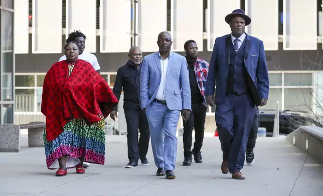 The family of Patrick Lyoya and Kent County commissioner Robert Womack, right, arrive outside the Kent County Courthouse in Grand Rapids, Mich., Monday, April 28, 2025. (Chris duMond/Detroit News via AP)