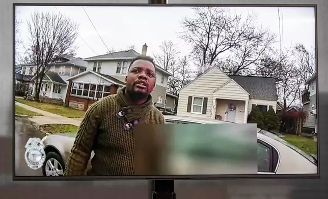 FILE - A TV display shows Patrick Lyoya as video evidence of a Grand Rapids police officer struggling with and shooting Patrick Lyoya is shown at Grand Rapids City Hall in Grand Rapids, Mich., Wednesday, April 13, 2022. (Grand Rapids Police Department via AP)
