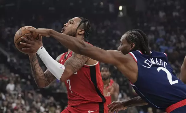 Houston Rockets forward Cam Whitmore, left, shoots as Los Angeles Clippers forward Kawhi Leonard defends during the first half of an NBA basketball game Wednesday, April 9, 2025, in Inglewood, Calif. (AP Photo/Mark J. Terrill)