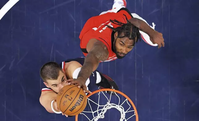 Los Angeles Clippers center Ivica Zubac, left, has his shot blocked by Houston Rockets forward Tari Eason during the first half of an NBA basketball game Wednesday, April 9, 2025, in Inglewood, Calif. (AP Photo/Mark J. Terrill)
