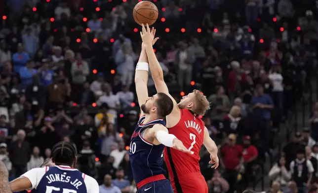 Los Angeles Clippers center Ivica Zubac (40) and Houston Rockets center Jock Landale (2) reach for the ball at tipoff during the first half of an NBA basketball game Wednesday, April 9, 2025, in Inglewood, Calif. (AP Photo/Mark J. Terrill)