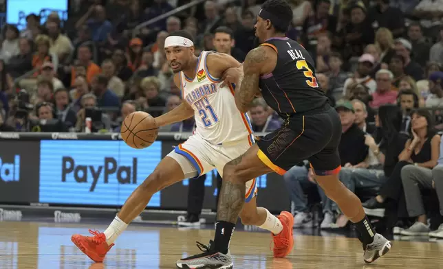 Oklahoma City Thunder guard Aaron Wiggins drives around Phoenix Suns guard Bradley Beal (3) during the first half of an NBA basketball game, Wednesday, April 9, 2025, in Phoenix. (AP Photo/Rick Scuteri)