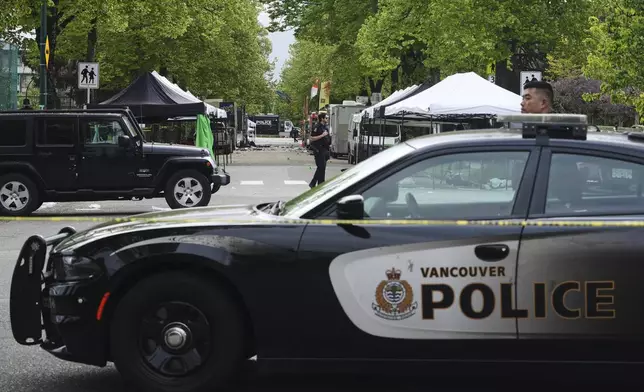 Vancouver Police survey the scene after a driver killed multiple people Saturday during a Filipino community festival Sunday, April 27, 2025, in Vancouver, British Columbia. (AP Photo/Lindsey Wasson)