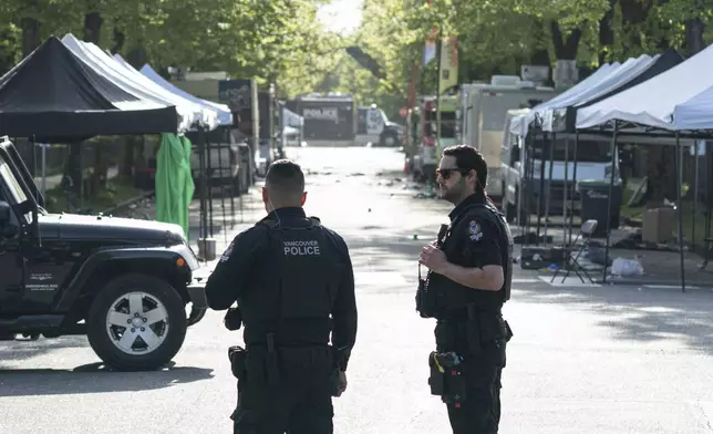 Vancouver Police officers secure a street in Vancouver, where a vehicle drove into crowd at a street festival on the night before, on Sunday April 27, 2025. (Rich Lam/The Canadian Press via AP)